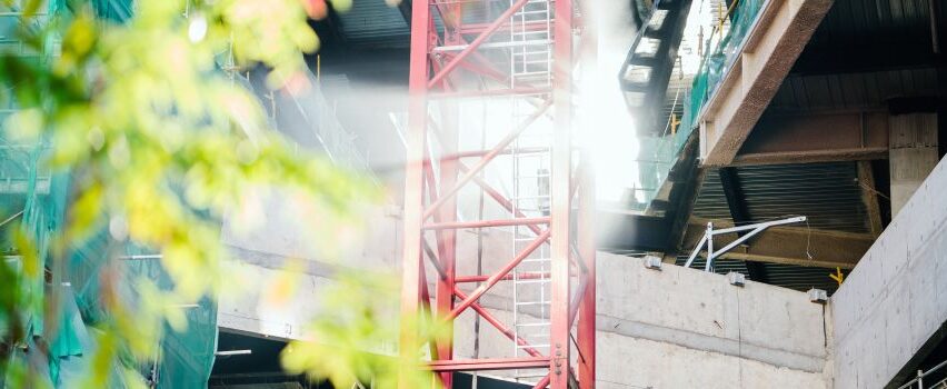green.leafed.tree.beside.red.metal.trusses.and.building.1194883.000 green.leafed.tree.beside.red.metal.trusses.and.building.1194883.000